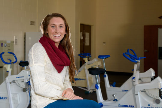 Kinesiology major Amanda Preserves sits on an exercise bike