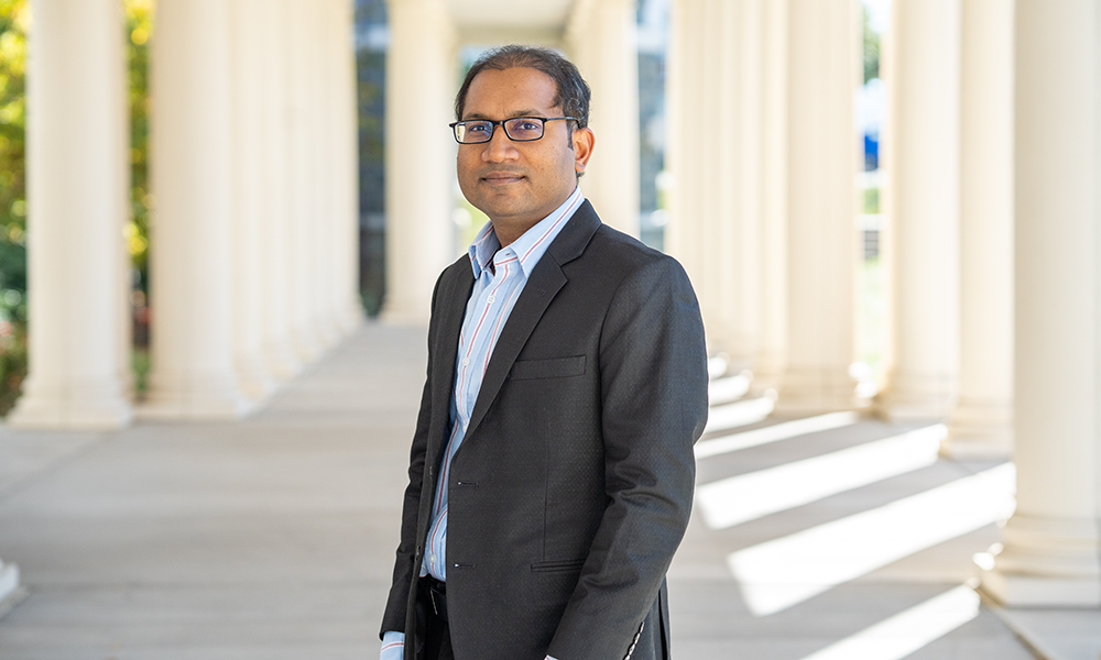 Sojib Zaman, Health Sciences professor, stands near the columns of Holland Yates Hall.