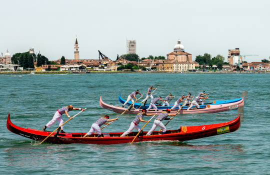 Men rowing a gondola in a foreign country