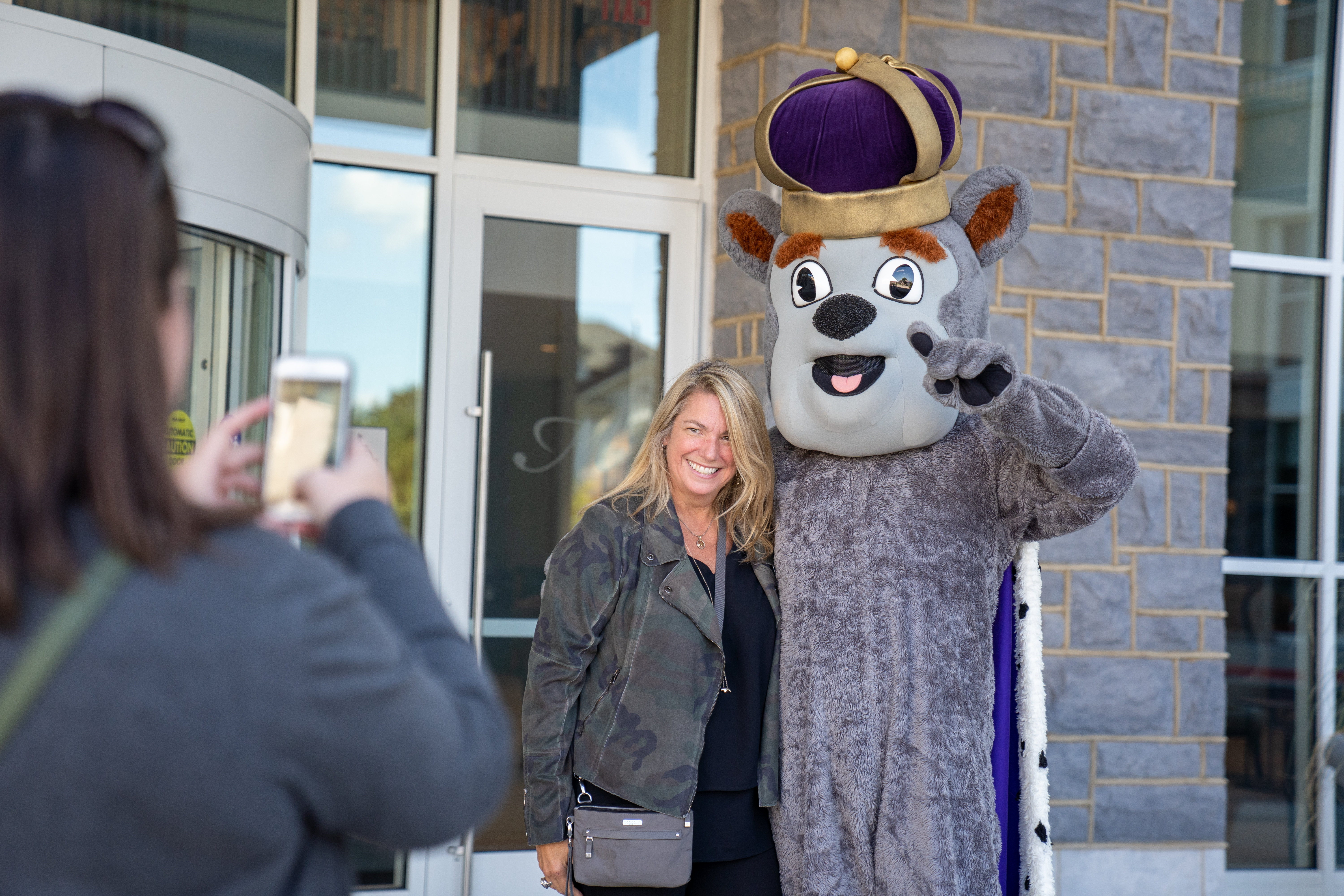 Mom taking a photo with Duke Dog at Hotel Madison