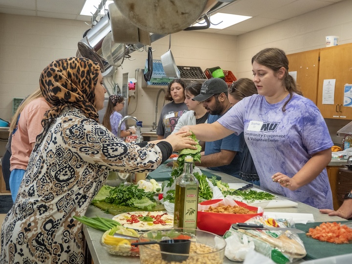 students preparing food in a kitchen
