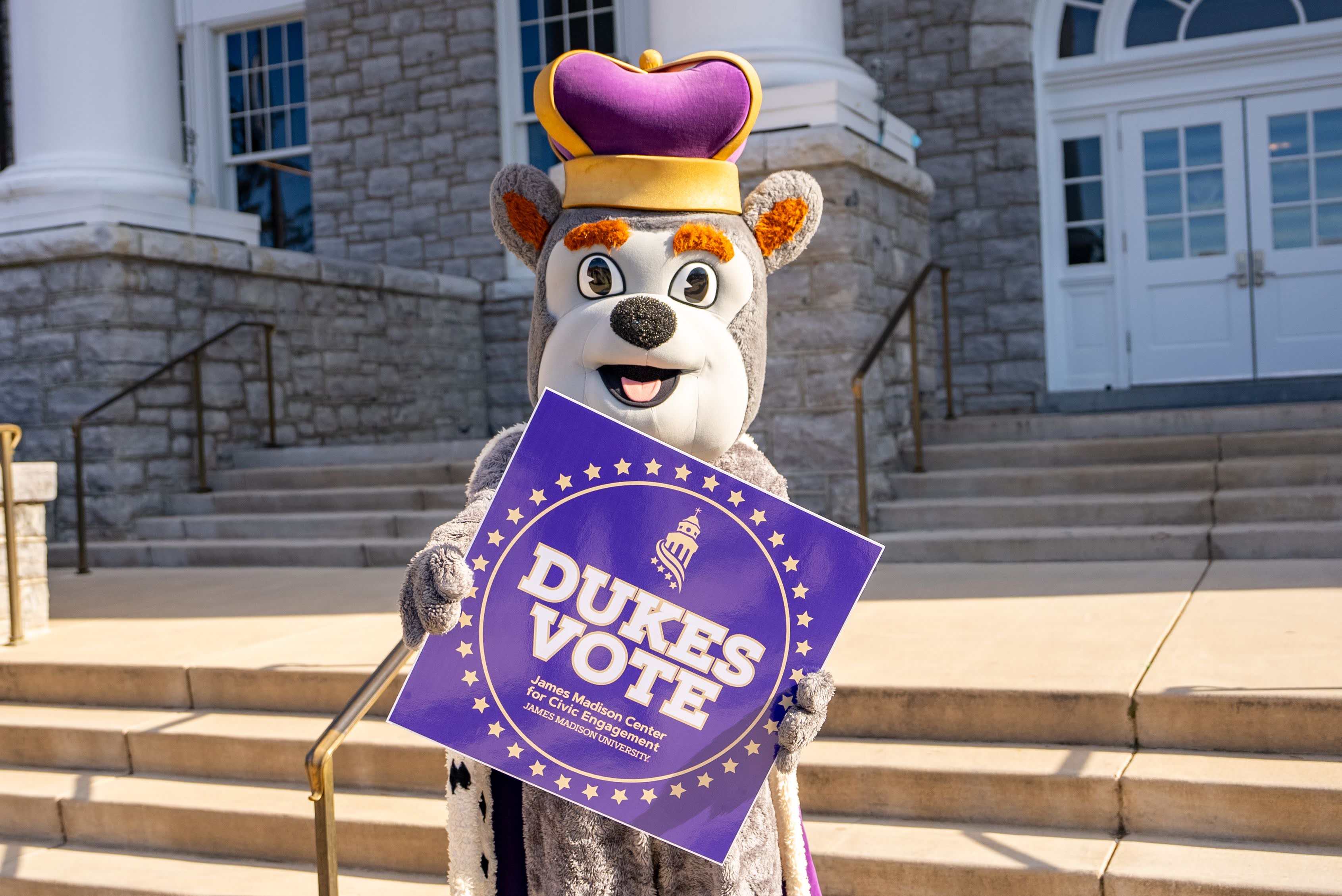 Duke Dog holding sign Dukes Vote