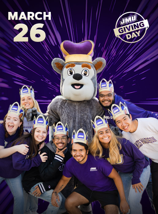 JMU Giving Day March 26, group of students wearing crowns around Duke Dog