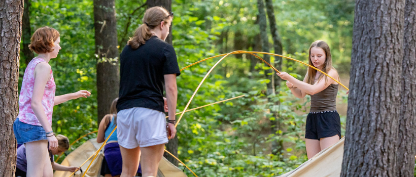 students setting up a tent