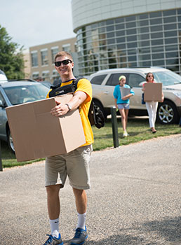 student moving a box