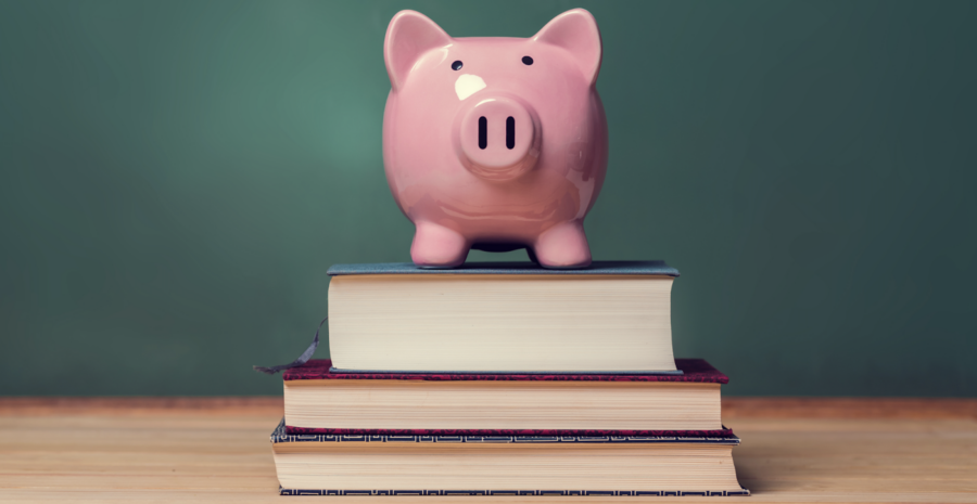 pink piggy bank on top of 3 books