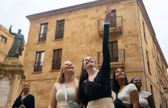 Students in a foreign country pointing up to something.