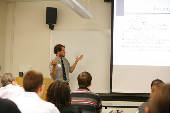 A student gives an oral presentation in a classroom.