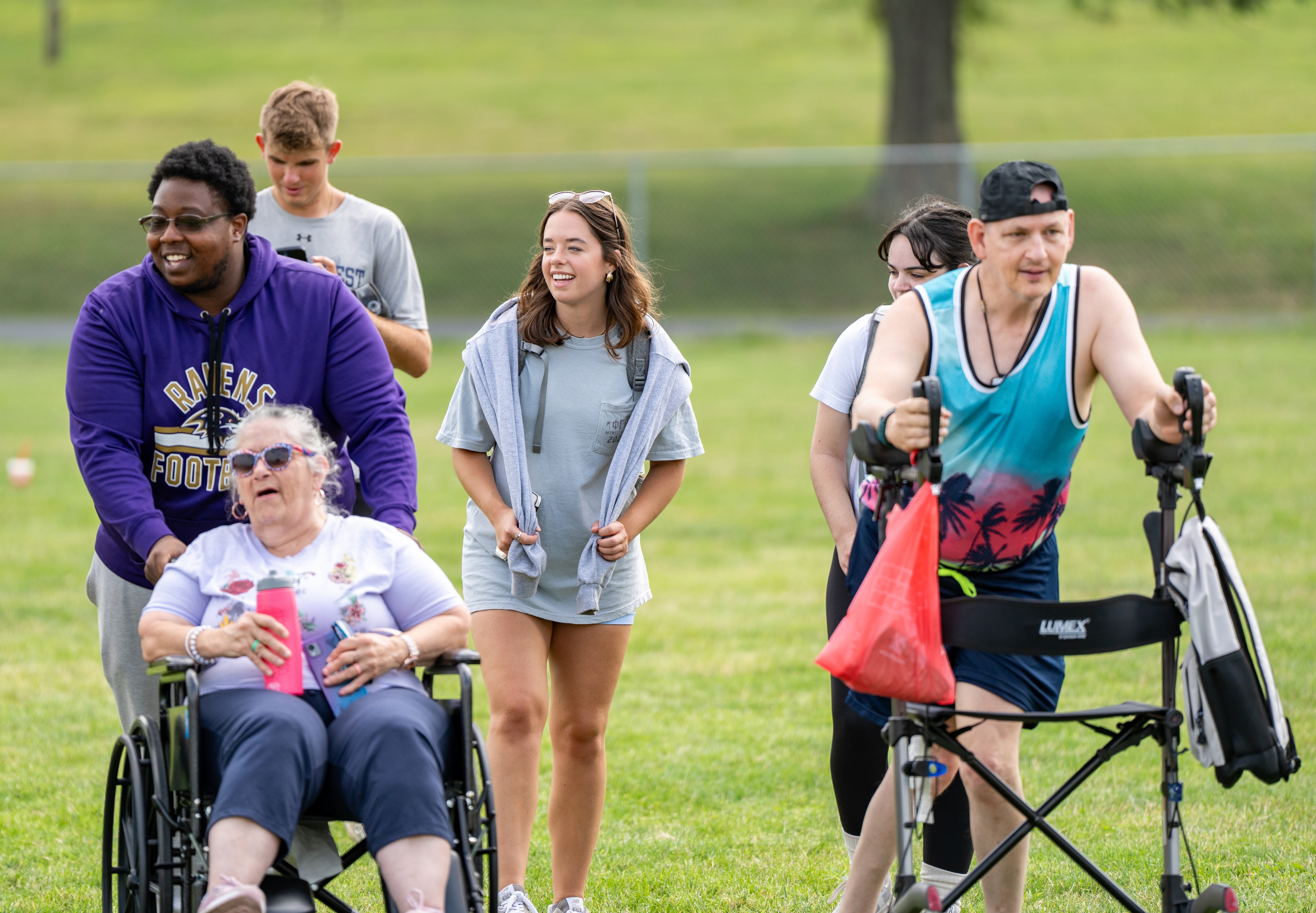 students pushing people in wheelchairs
