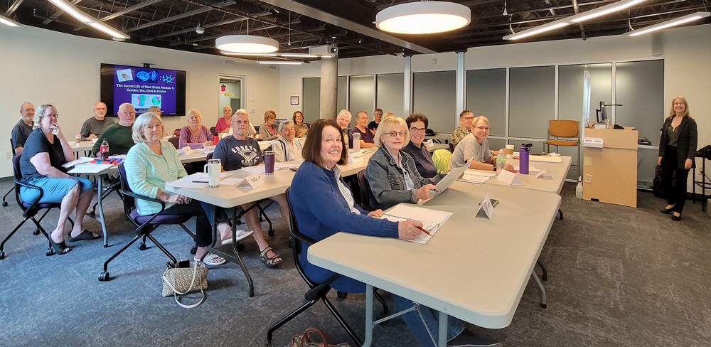 room of adults sitting and smiling at camera