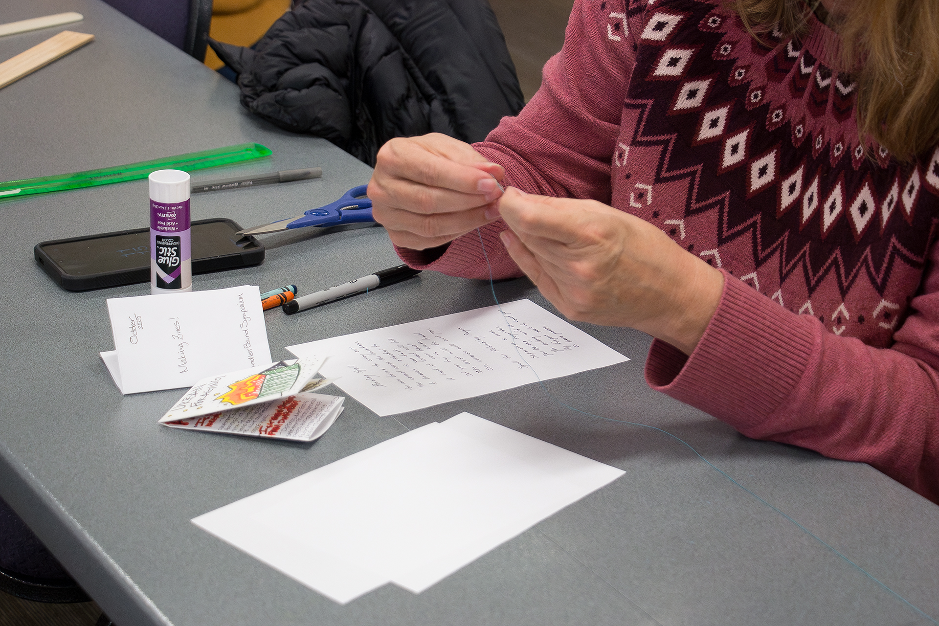 zine workshop participant threading needle