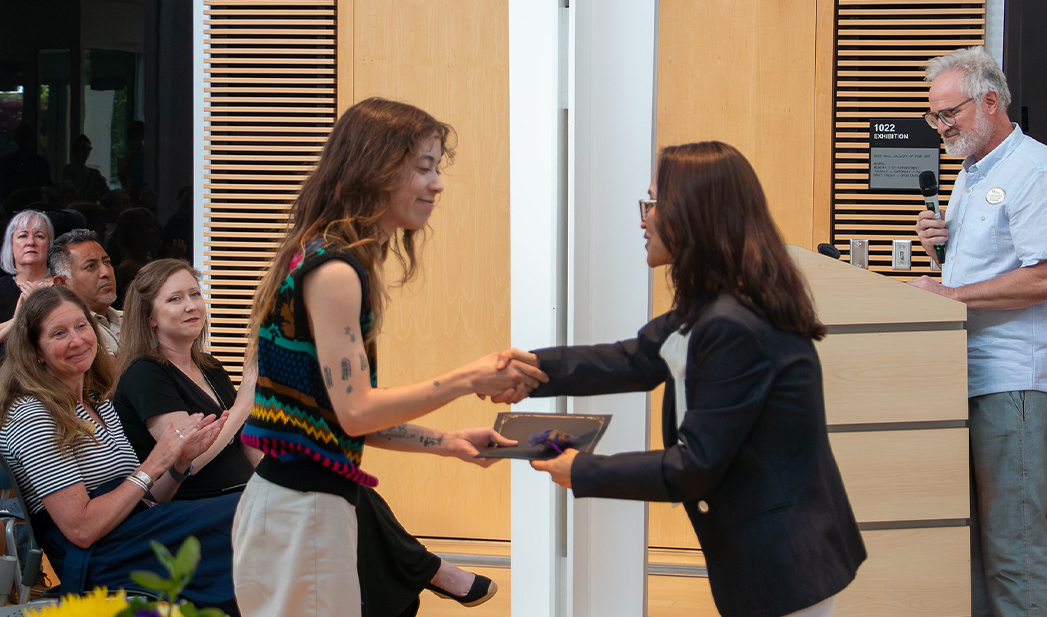 Achilles Vasquez accepts award from SADAH Director MiKyoung Lee