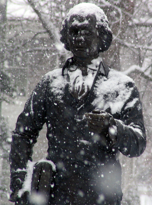 Snow covers the James Madison statue.