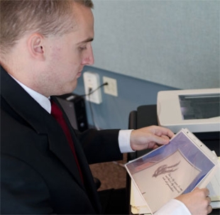 History major John Bowden prepares to digitize an artifact brought to the History Harvest.