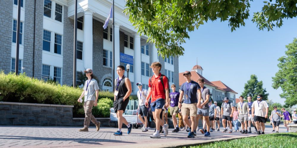 A group of students walking outside of Wilson Hall at JMU.