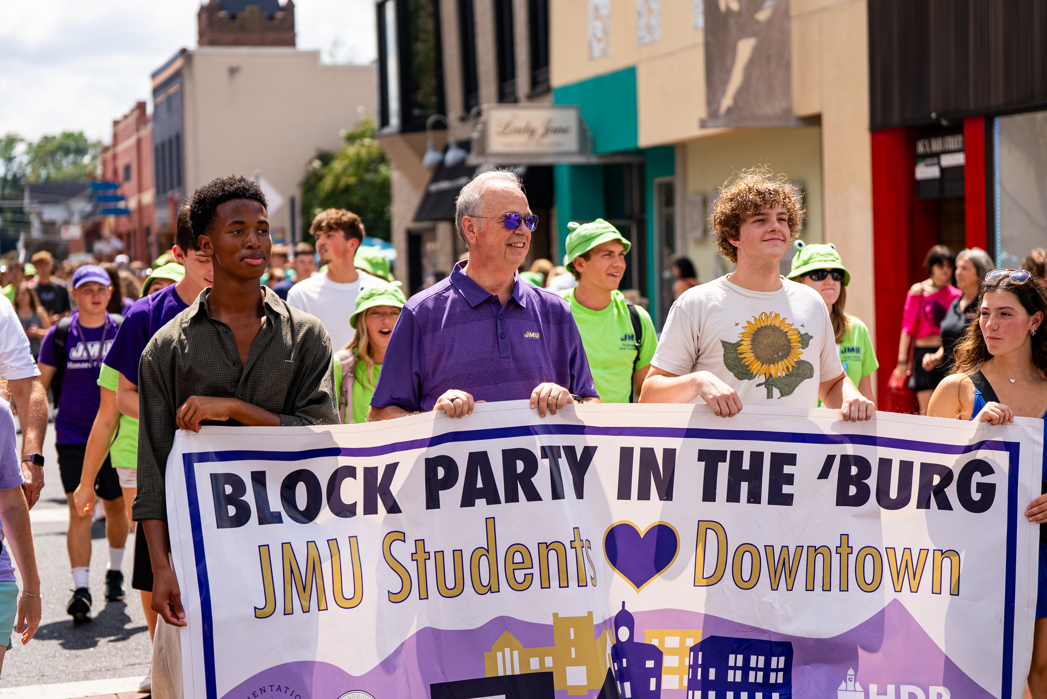 JMU President Jim Schmidt leading students in the Block Party in the 'Burg parade.