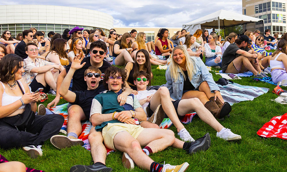 Group of friends laying on Festival Lawn in a crowd