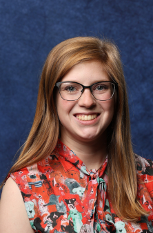 College for Kids instructor smiling at the camera wearing glasses