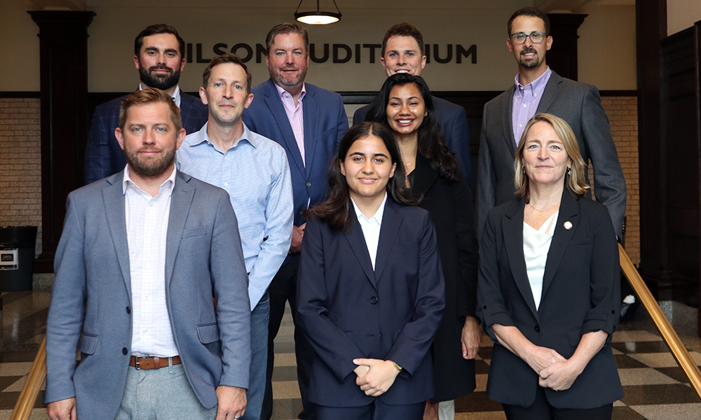 Nine people standing in three rows, members of the Law Alumni Board.