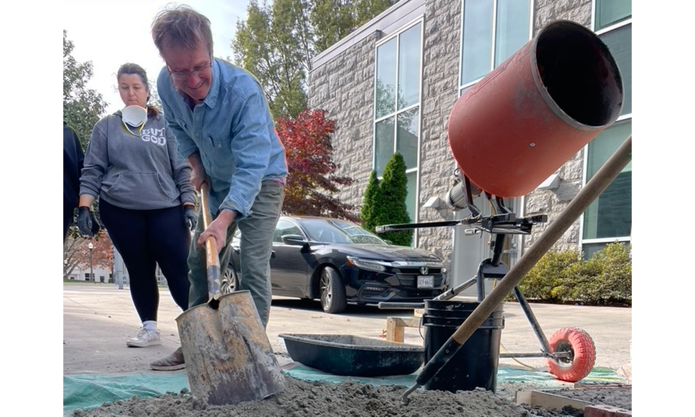 instructor mixing concrete