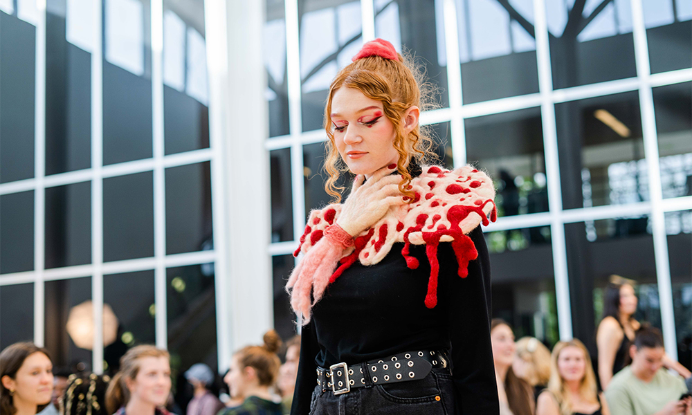 student wearing fiber art