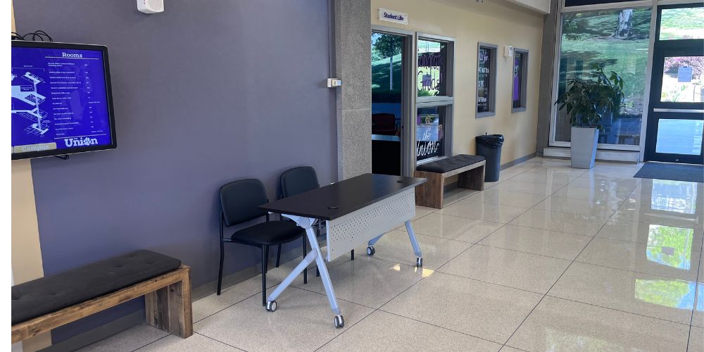 The Union Info \ Sales Table 2 is outside of Student Life office on Warren Third Floor.  A table and two chairs are provided.