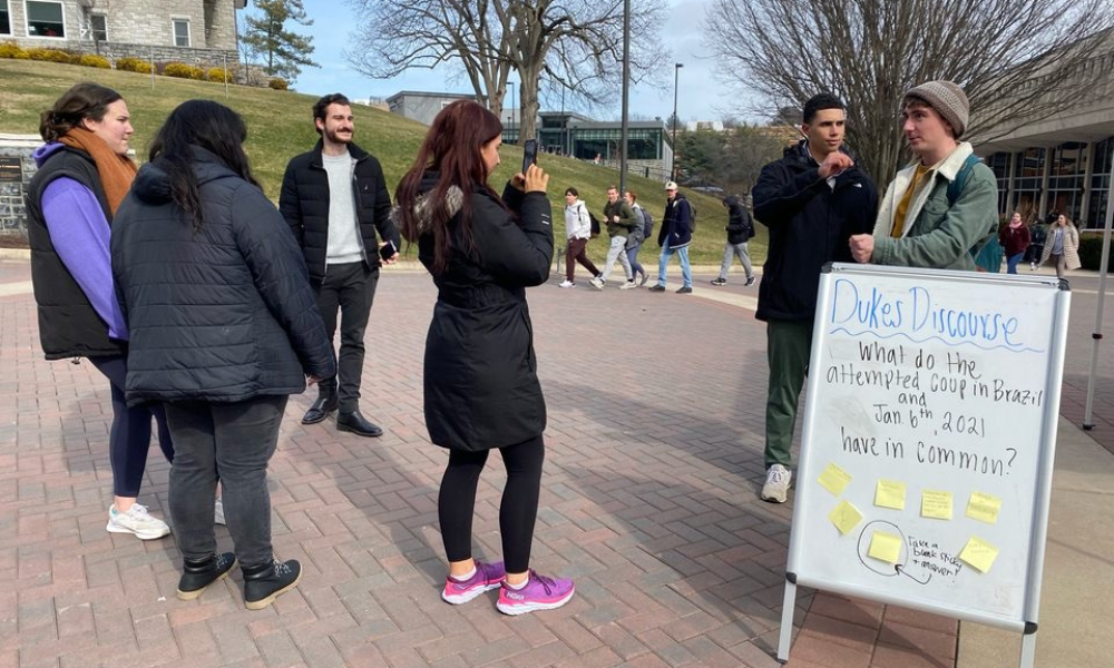 Dukes discourse whiteboard and students at Warner Commons